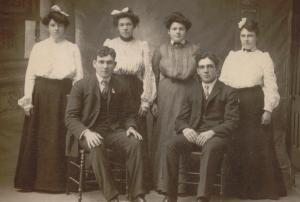 Tom is seated on the left, pictured with his sisters and brother.